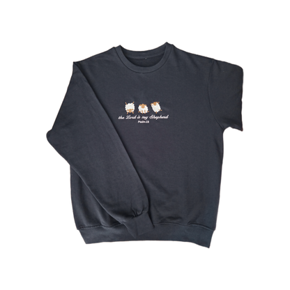 Full front view of a navy blue crewneck sweatshirt with high-quality custom embroidery of 3 fluffy white and brown sheep above the scriptures "the Lord is my Shepherd Psalm 23" in white thread.