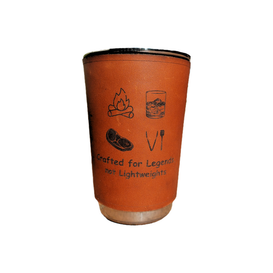 400 ml stainless steel drinking glass wrapped in genuine leather sleeve engraved with “Crafted for legend, not lightweights” and camping and braai icons, on white background.