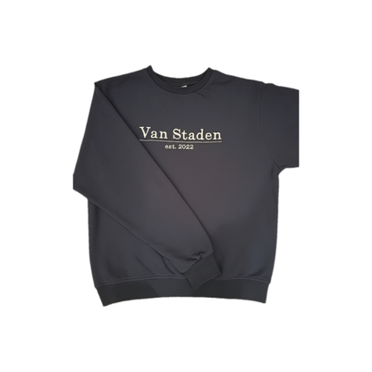 Navy sweatshirt laid flat with one sleeve folded across the body to show width and length, featuring personalised white embroidered surname and established date