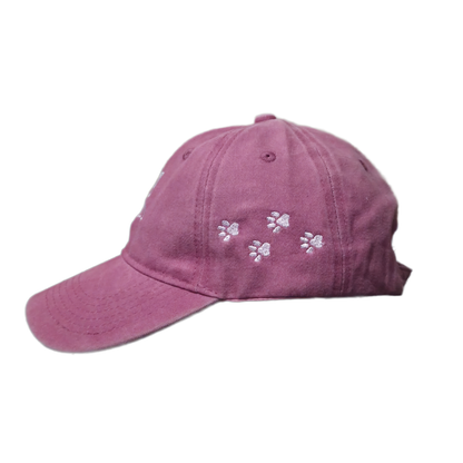 Left side view of pink Dog Mom embroidered baseball cap showing four paw prints on the side