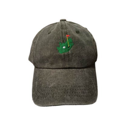 Front view of light grey 6-panel baseball cap with South Africa-shaped golf green embroidery, including golf hole, flag, and golf ball