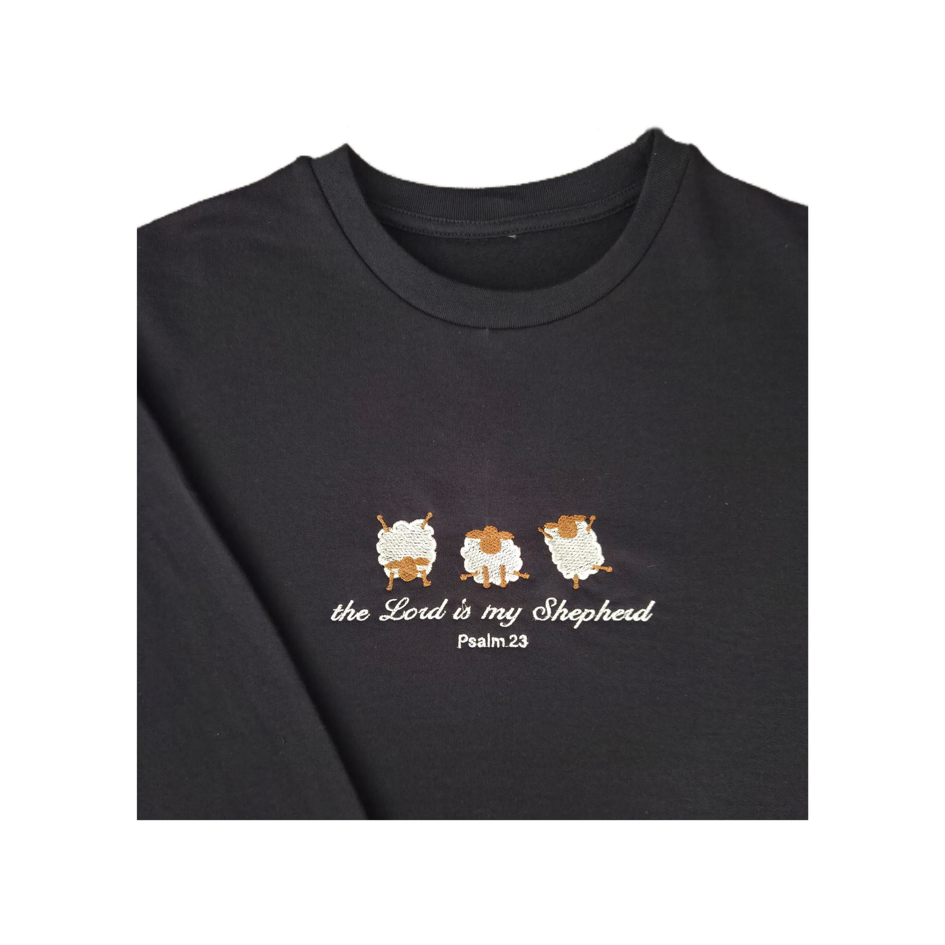 Close-up macro shot of the detailed satin stitch embroidery on a navy sweatshirt, showing three cute textured sheep and white script lettering for the Christian bible verse Psalm 23.